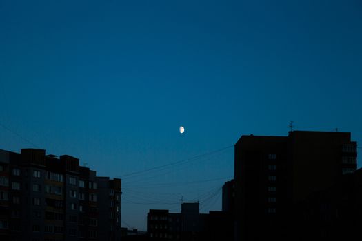 Rising moon summer night over the city skyline