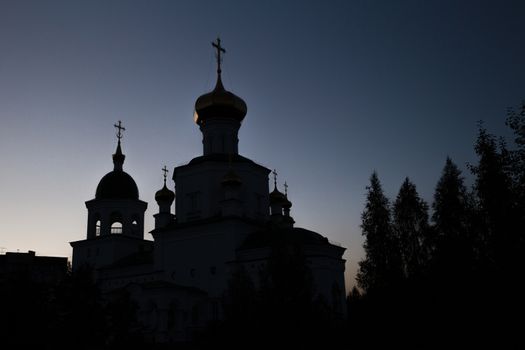 Evening view of the white-stone church near park