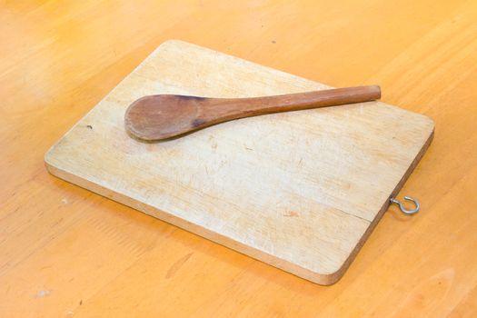 Chopping block and wood spoon on the table