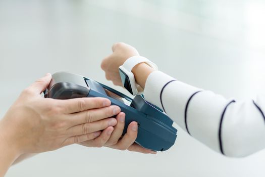 Woman using smart watch to pay