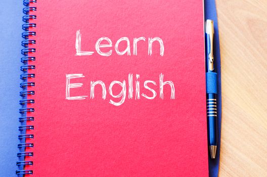 Learn english text concept write on notebook with pen