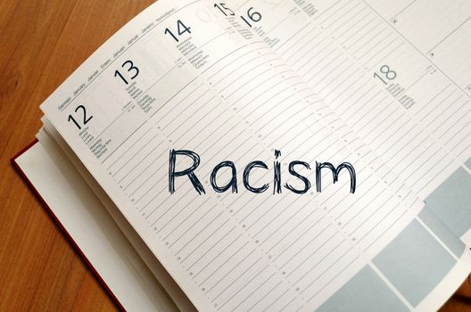 Racism text concept write on notebook