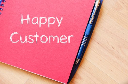 Happy customer text concept write on notebook with pen