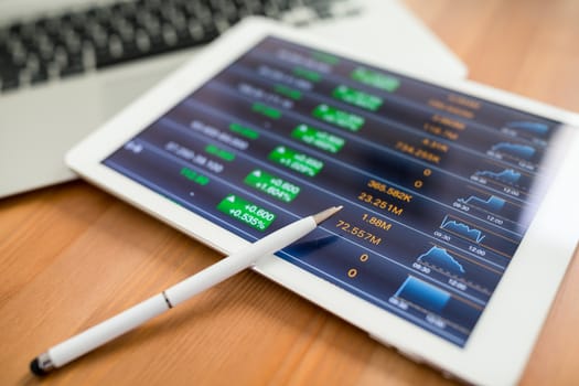 Analyzing stock market with digital tablet