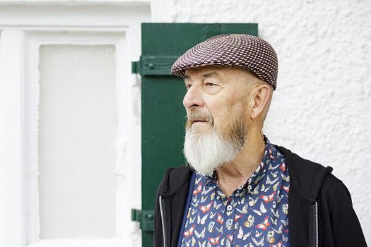 An image of an old man with a beard outdoor