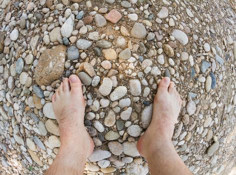 Person standing on bunch of rough rocks