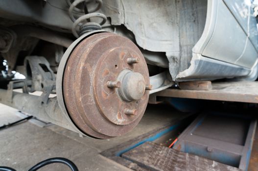 Rusty Rear Car Wheel Hub with Drum Brake System and Suspension