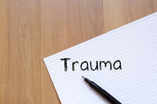 Trauma text concept write on notebook with pen