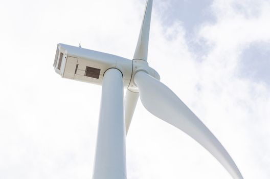 Wind turbine generating electricity in Holland, photographed from below.