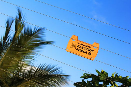 Danger high voltage sign on a fence
