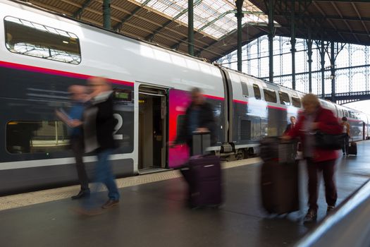Subway train at the station. People coming to or leaving train station platform. Motion blur. City life.