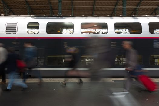 Subway train at the station. People coming to or leaving train station platform. Motion blur. City life.