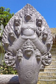 Garuda surrounded by serpent heads on this naga balustrade at Buddhist Temple Wat Preah Prom Rath in Siem Reap, Cambodia