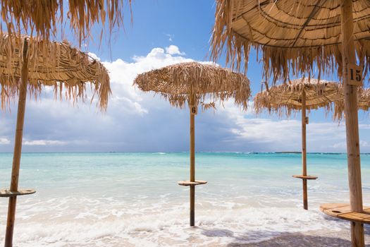 Straw sunshades at Elafonissi beach on Crete island, Greece.