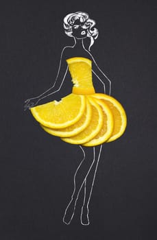 Creative concept photo of orange slices as a dress with illustrated woman on black background.