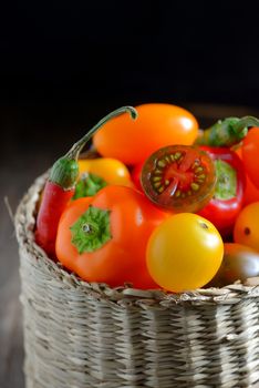 Fresh ripe colorful vegetables tomatoes in basket