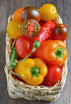 Fresh ripe colorful vegetables tomatoes in basket