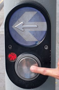 Arrow and button to press for Pedestrian Crossing