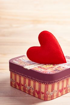 Valentines Day. Love red heart handmade on gift box. Retro romantic styled. Vintage concept on wooden background. Copyspase