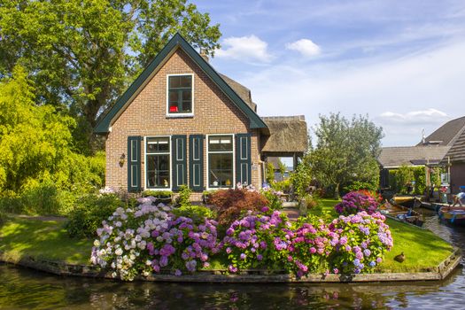 GIETHOORN, NETHERLANDS -typical dutch county side of houses and gardens