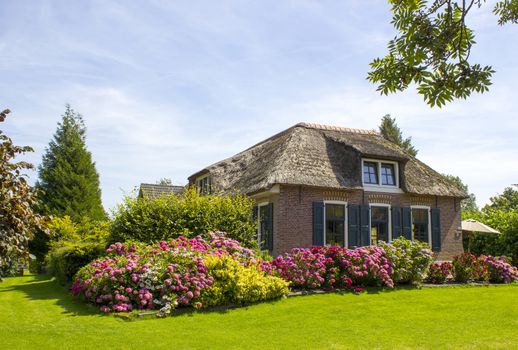 GIETHOORN, NETHERLANDS -typical dutch county side of houses and gardens