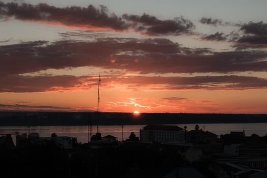 Sunrise over Mekong River in a Mukdahan city sky