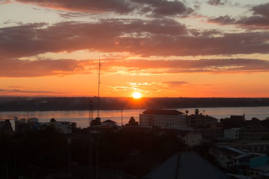 Sunrise over Mekong River in a Mukdahan city sky