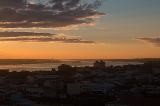 Sunrise over Mekong River in a Mukdahan city sky