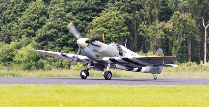 LEEUWARDEN, THE NETHERLANDS - JUNE 10, 2016: A vintage Spitfire fighter plane on the runway during a demonstration at the Royal Netherlands Air Force Days at Leeuwarden on June 10, 2016.