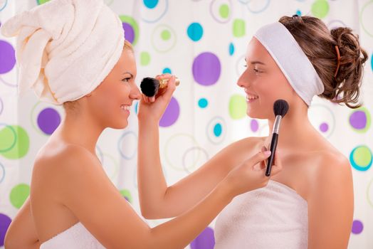 Two young cute woman having fun and get ready to start their day.