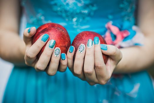 Beautiful hands with wonderful nails Holding a Ripe Peaches