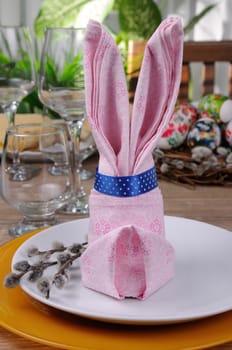 Napkin folded as an Easter bunny on a plate
