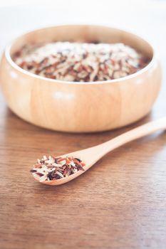 Organic Dry Multi Grain Rice in wooden bowl, stock photo