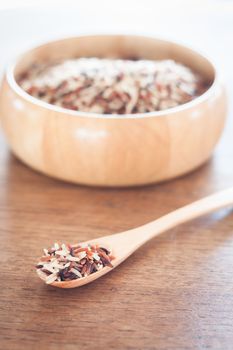 Organic Dry Multi Grain Rice in wooden bowl, stock photo