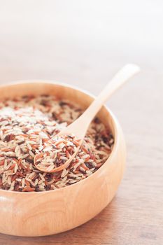 Organic Dry Multi Grain Rice in wooden bowl, stock photo