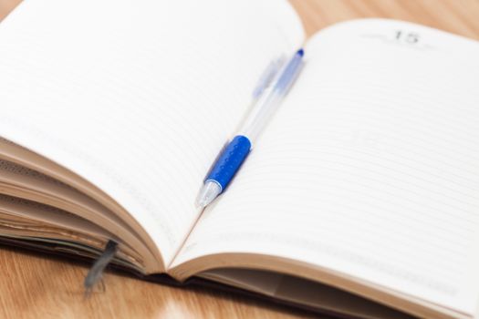 Classic leather notebook with pen, stock photo
