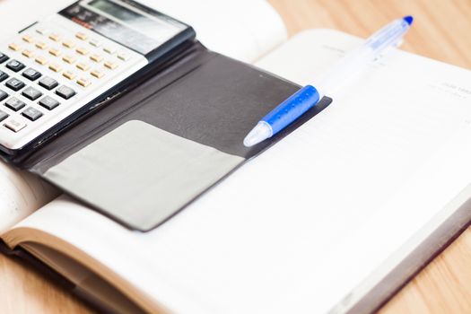 Classic leather notebook with pen and calculator, stock photo