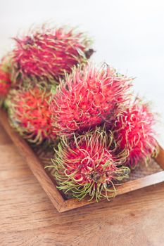 Fresh rambutans on wodden tray, stock photo