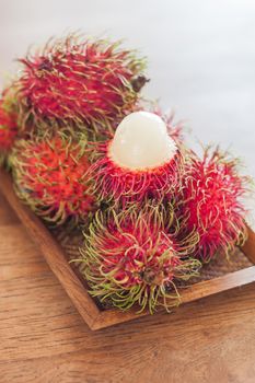 Fresh rambutans on wodden tray, stock photo