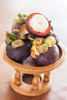 Group of mangoesteen on wooden tray, stock photo