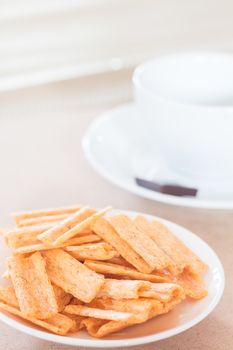 Snack on white plate with coffee cup, stock photo