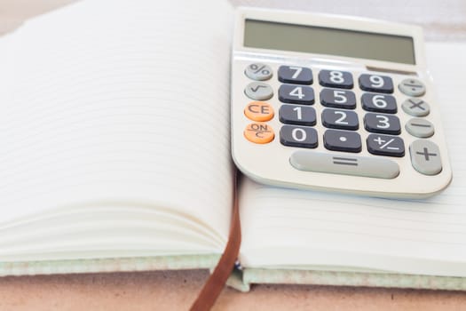 Calculator on blank notebook, stock photo