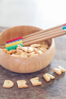 Dream alphabet biscuit on wooden table, stock photo