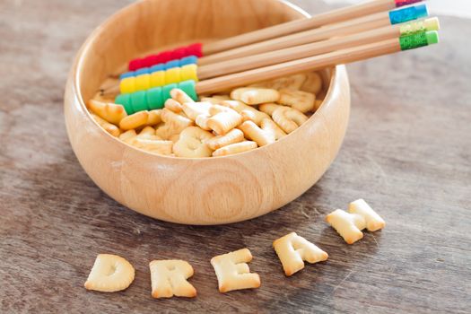 Dream alphabet biscuit on wooden table, stock photo