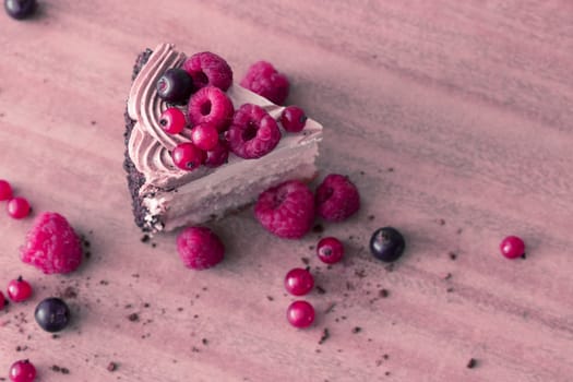 peace of cake decorated with fresh berries, toned pink