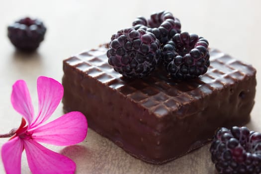 chocolate cake with blackberry on top, flower