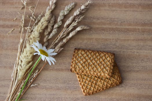 fresh crispy cereal cookies ears and flowers on rustic wooden table