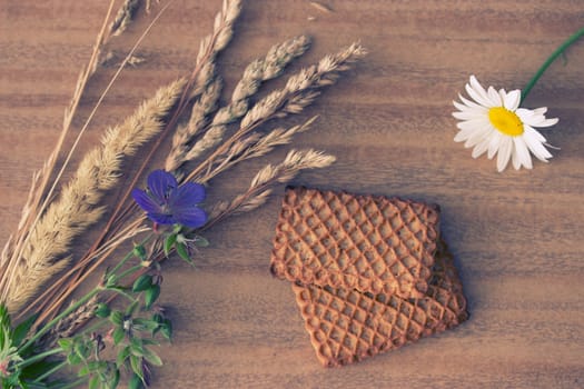 fresh crispy cereal cookies ears and flowers on rustic wooden table