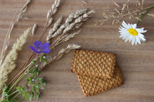 fresh crispy cereal cookies ears and flowers on rustic wooden table