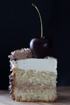 slice of cake with cherry on top, dark colours, toned